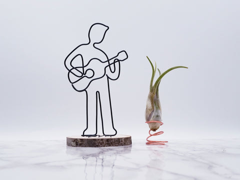 Wire sculpture of male guitar player