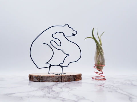 Wire sculpture of mama bear and baby bear embracing